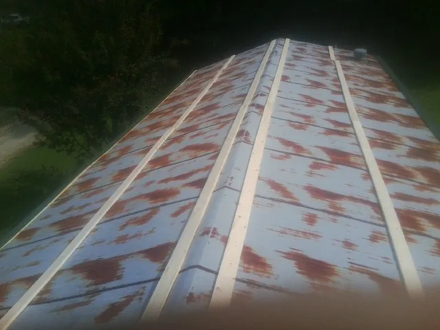 Rusted metal roof panels with new wood purlins before replacement — Storm Damage Roof Repair in Lyman by Roofing Brothers